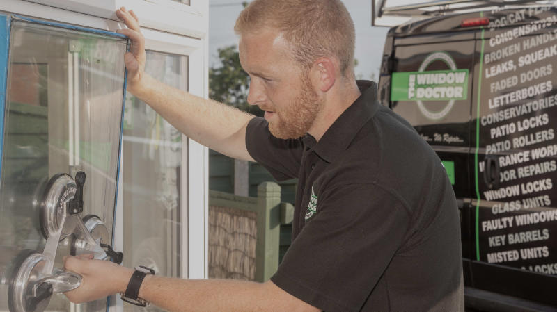 A photo of a Window Doctor employee fitting a door lock mechanism